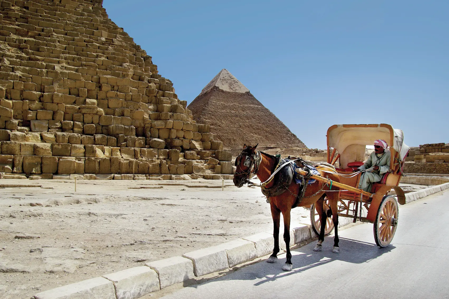 Pyramids of Giza Cart A local horse cart with driver waits for travellers in front of the Pyramids of Giza