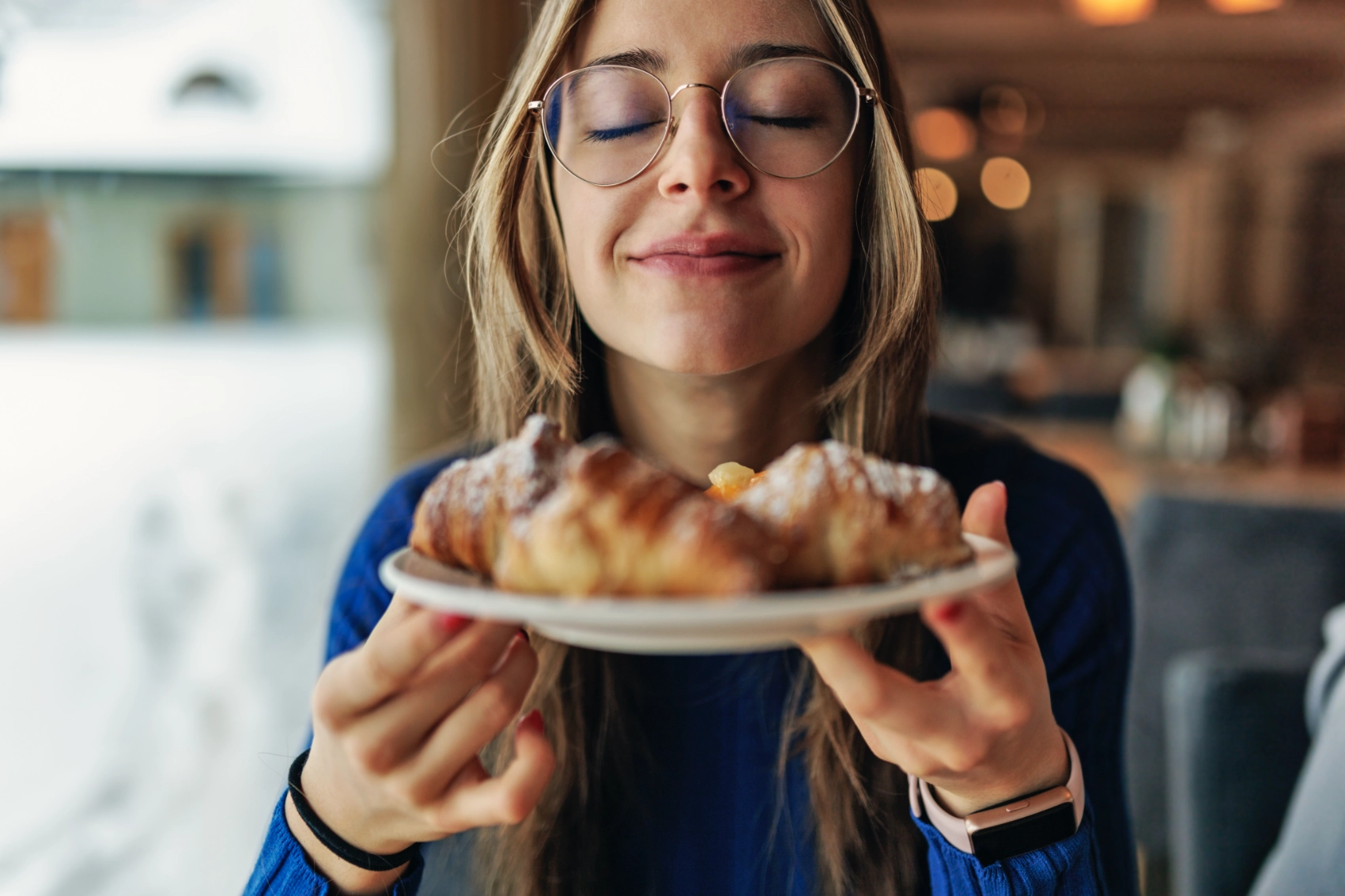 Eating in Wrocław, Poland A woman traveller holds a plate of pastries up to her face in Wrocław, Poland