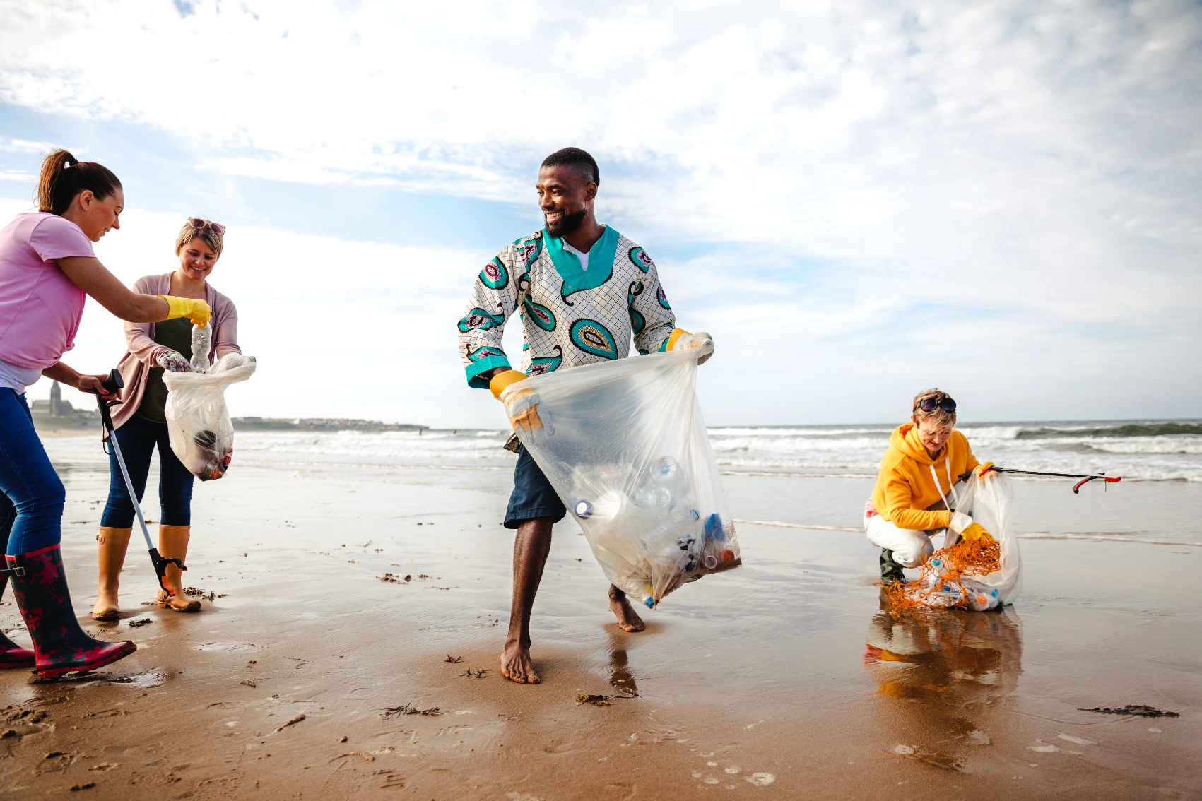 Beach cleanup Volunteers clean up trash on a beach
