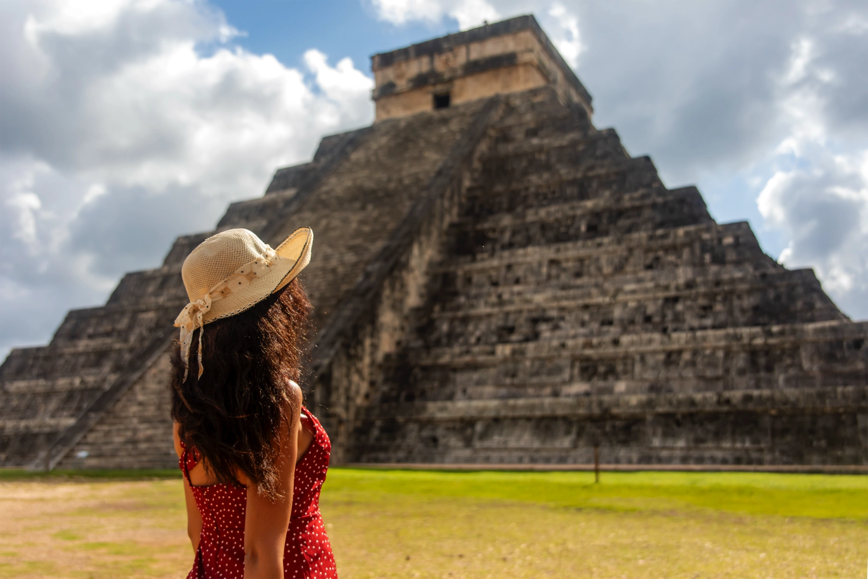 Chichén Itzá, Mexico A traveller stands in front of a pyramid at Chichén Itzá, Mexico