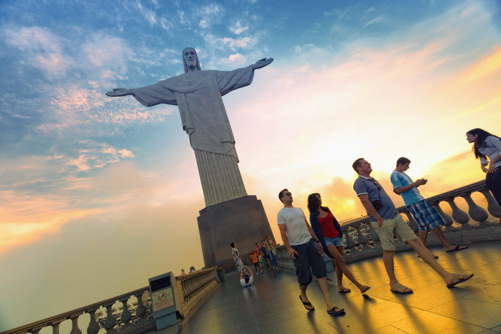Christ the Redeemer, Brazil Travellers walk in front of the Christ the Redeemer statue in Brazil