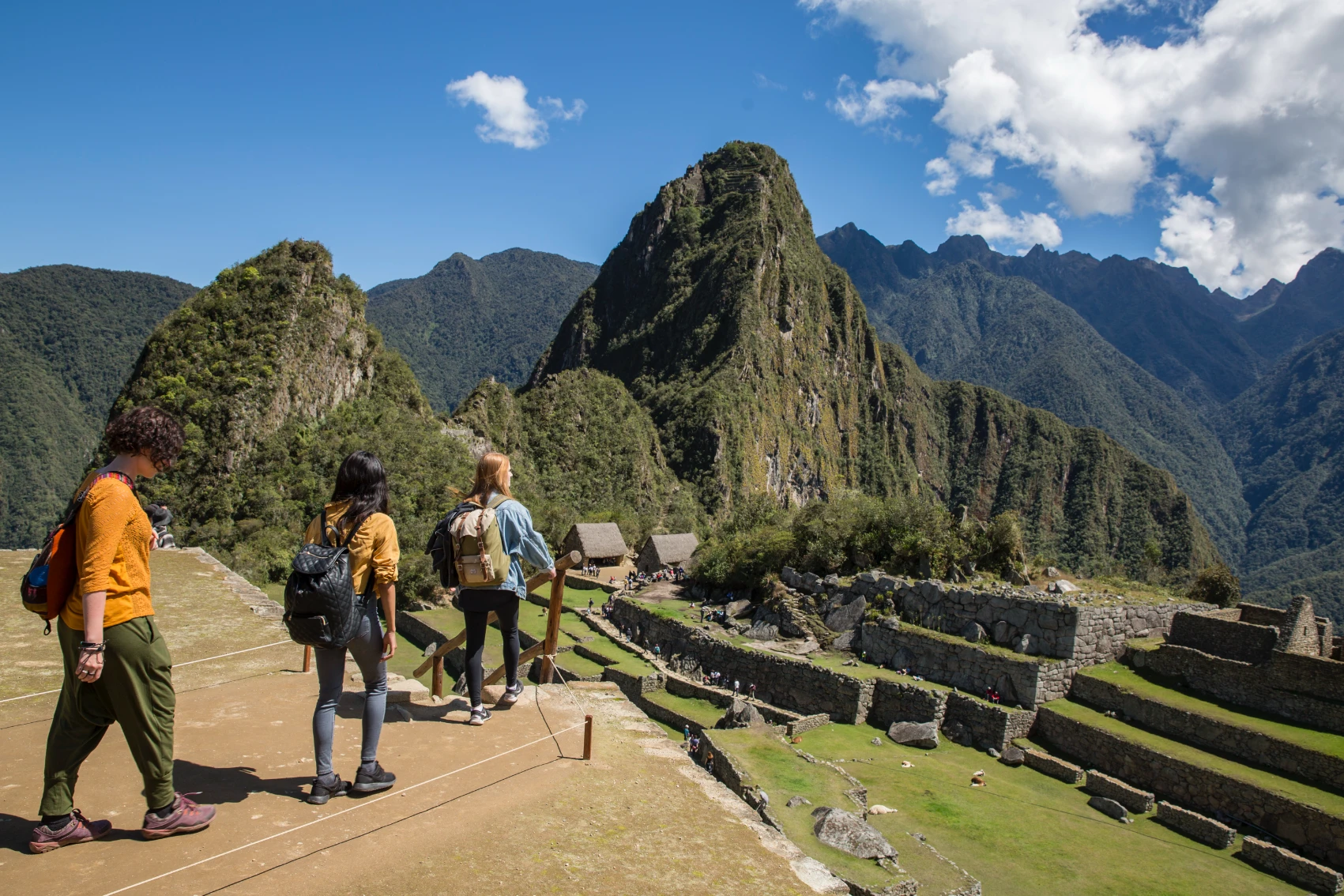 Machu Picchu, Peru Hikers look over the ruins of Machu Picchu in Peru