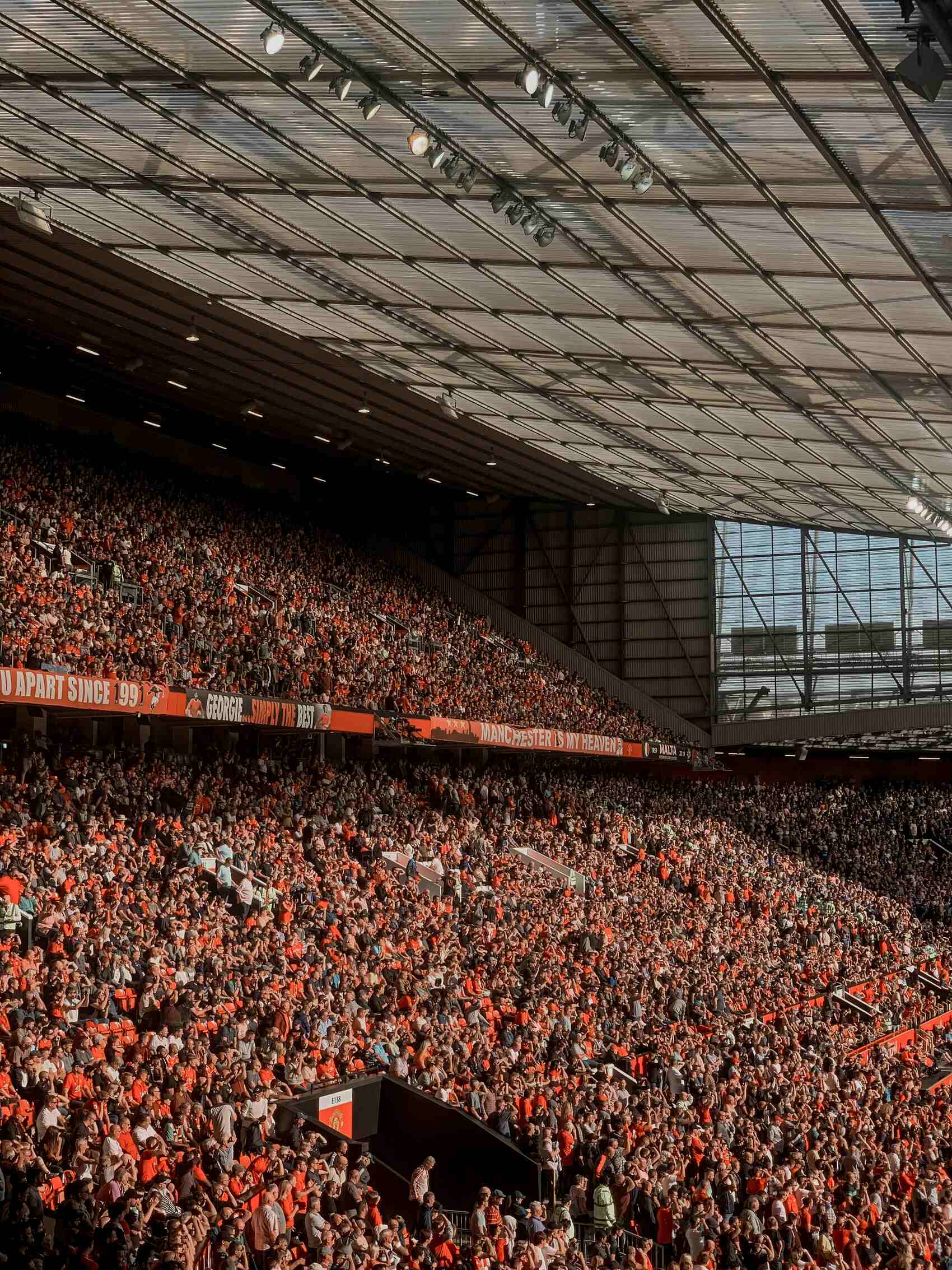 Crowds watching a match at a football stadium — Dan Parker