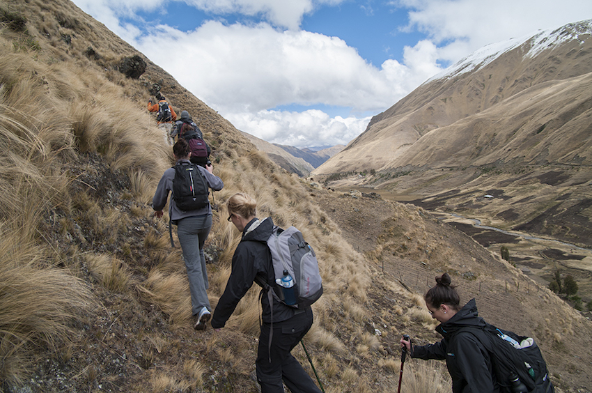 Trekkers walking up an inclide.