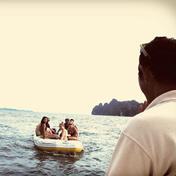 passengers on a zodiac as it approaches the sail boat