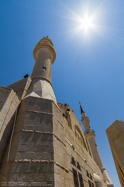 starbursting sun over building in jordan