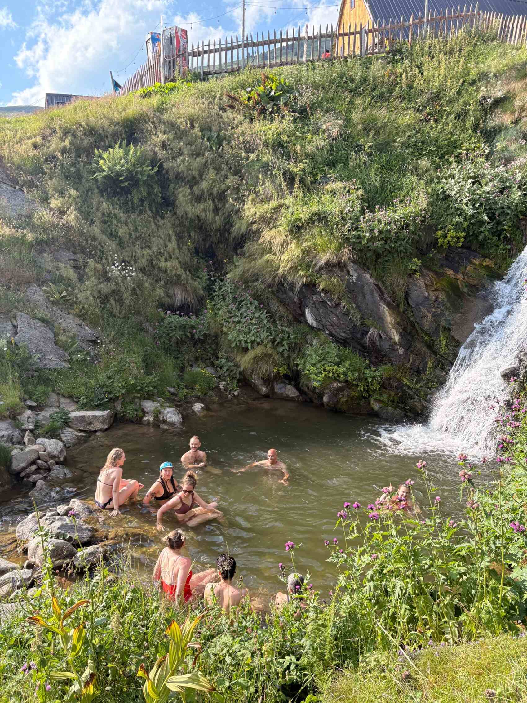 CEO Tom Leonard and other travellers in a waterfall in Montenegro