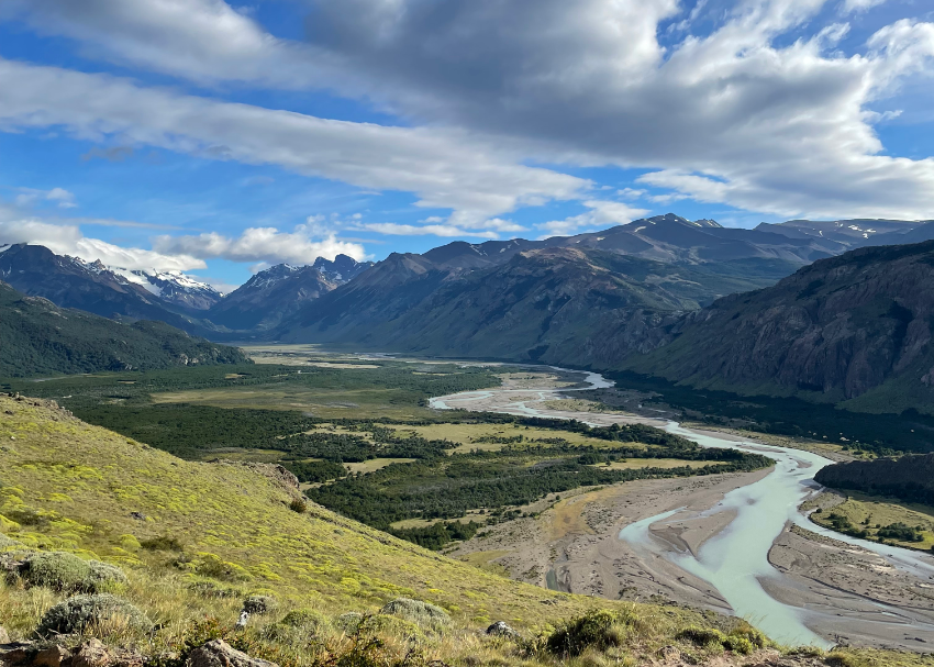 milky serpentine rivers meander through the valley with mighty Patagonian peaks on all sides