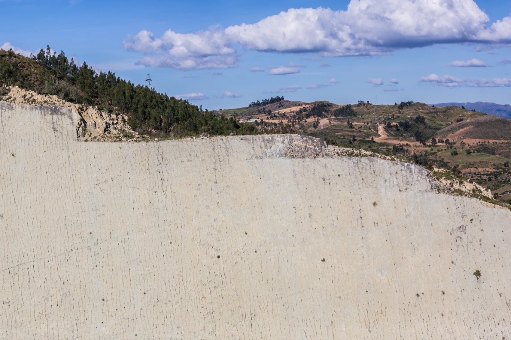 An impressive limestone wall face showcases prehistoric dinosaur tracks near Sucre, Bolivia