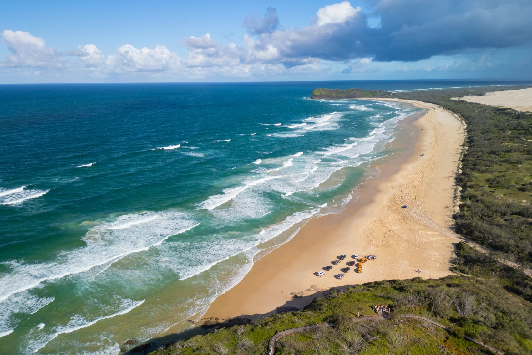 Aerial view of 4x4s on 75 Mile Beach in K'gari