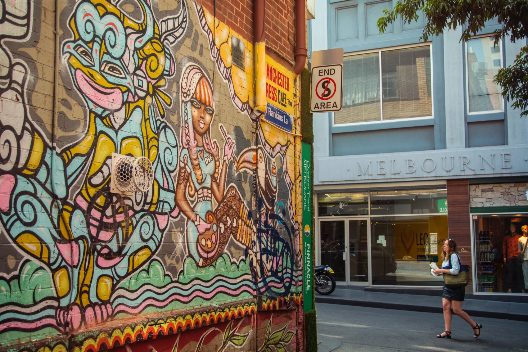 A woman walks in a laneway covered with street art in Melbourne, Australia