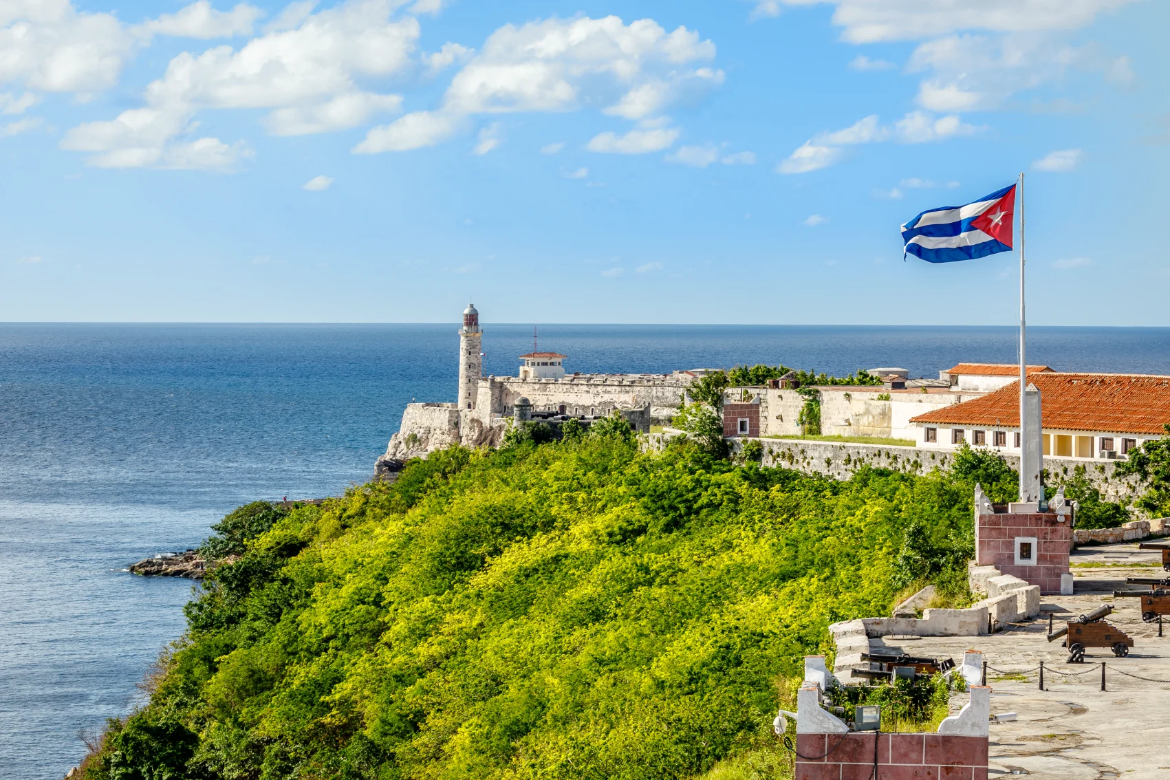 The Cuban flag flies in front of Morro Castle in Havana, Cuba