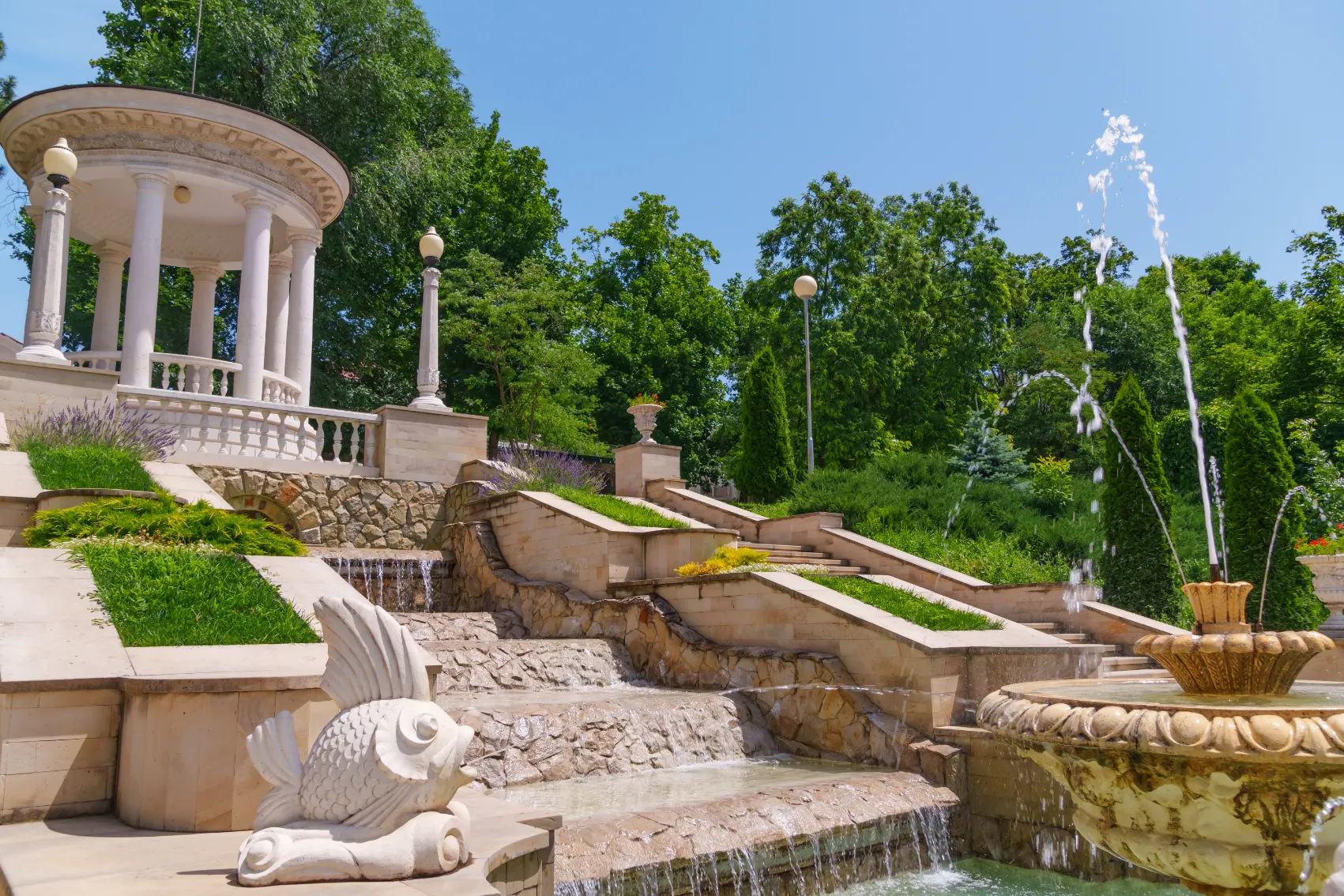 Fun goldfish statues spit water at the fountain at Valea Morilor Lake in Chisinau