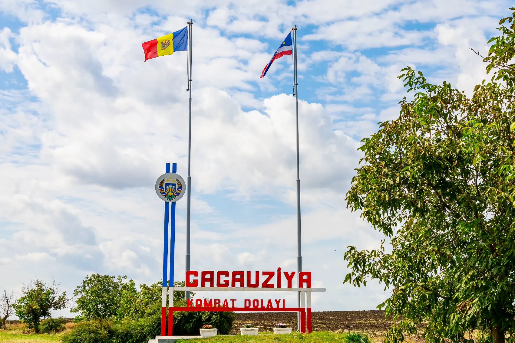 Flags fly over a Gagauzia sign marking the autonomous region in Moldova