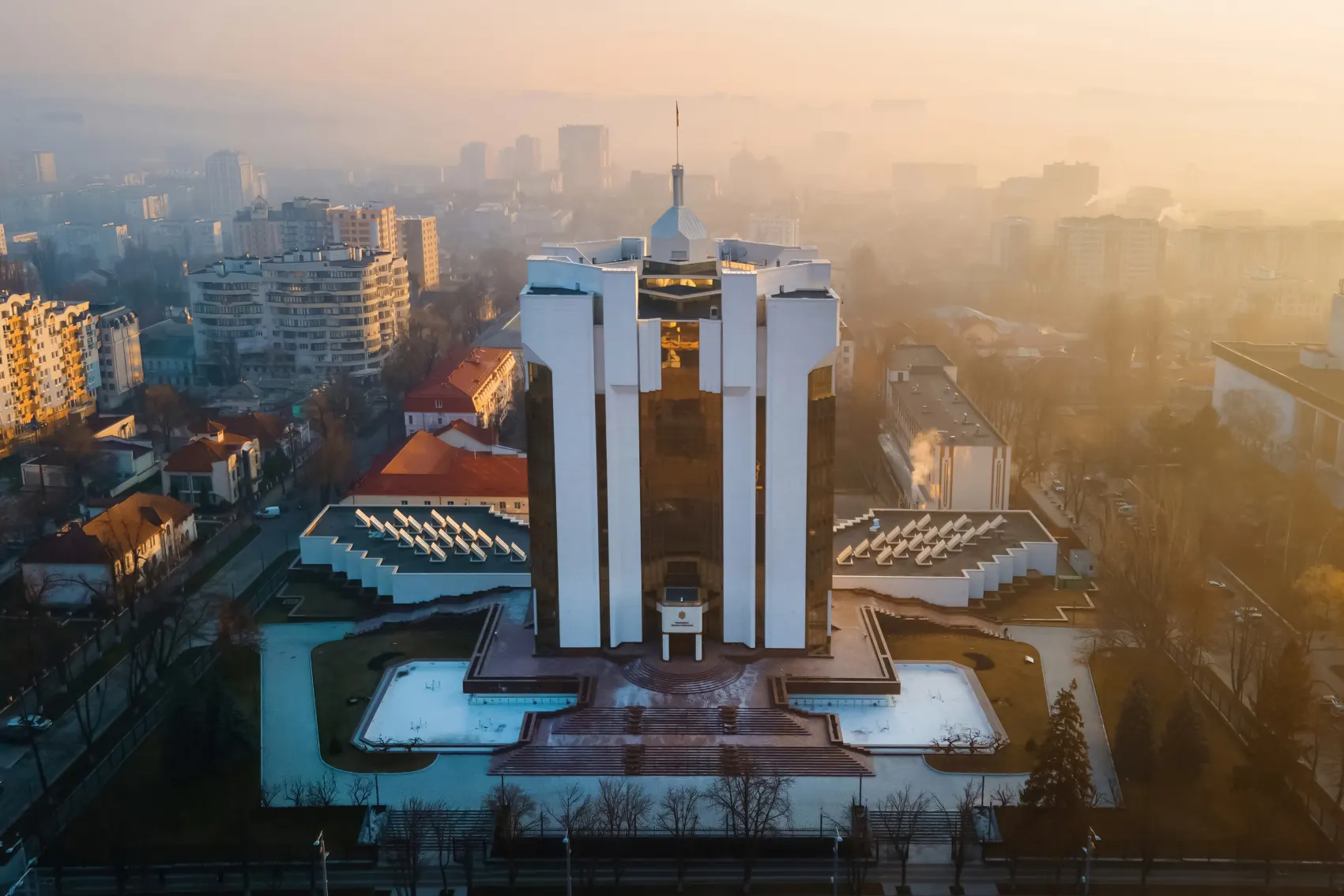 The late Soviet-era style Presidential Building stands out in a pink sunset over Chisinau