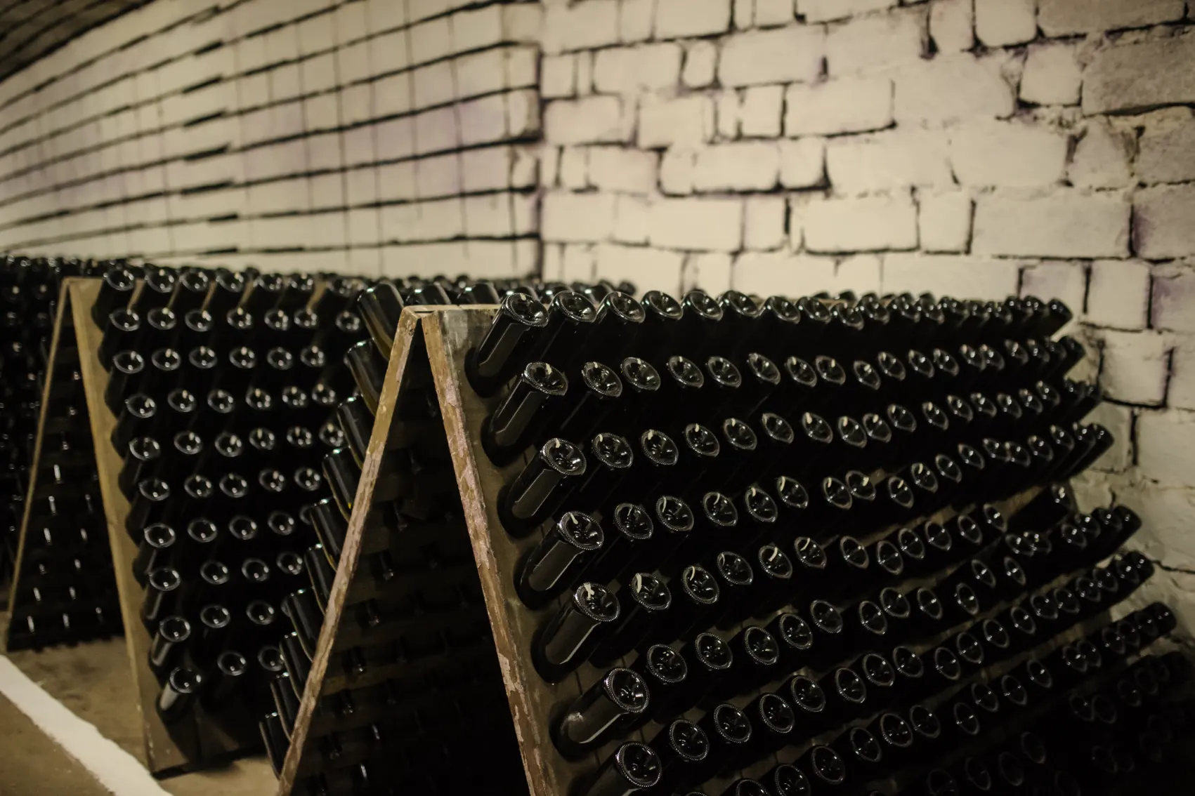 Rows of wine bottles line up neatly in the underground wine city of Cricova Winery
