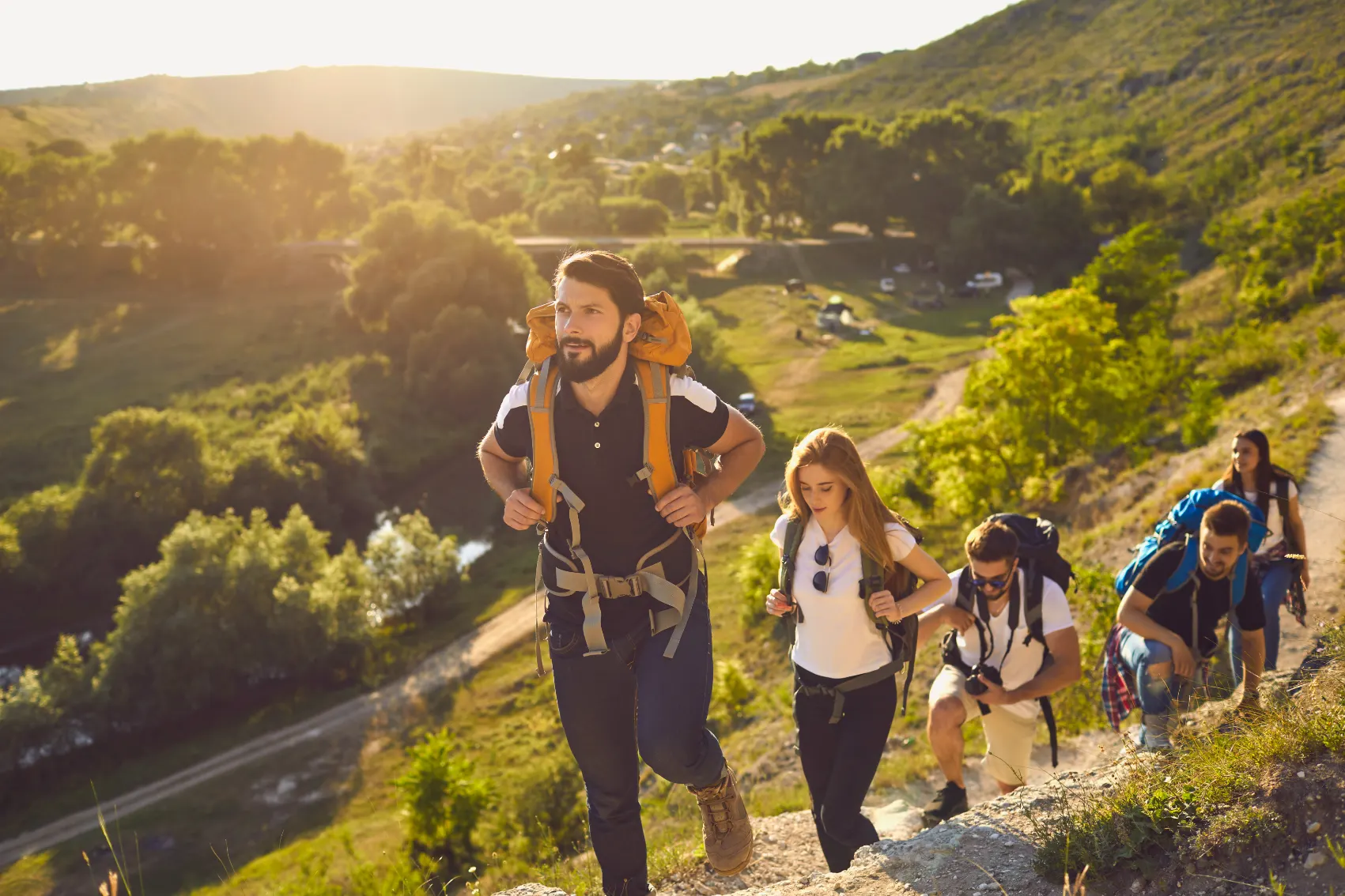 A group of young people with backpacks hike together in Moldova