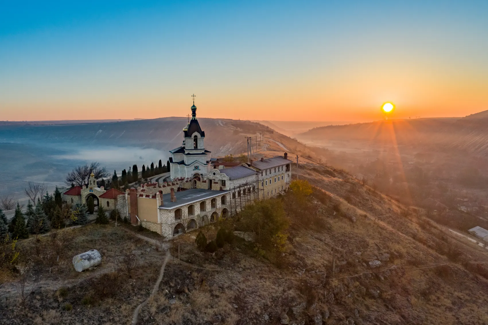 A dreamy sunset highlights the magnificent architecture of Old Orhei Monastery