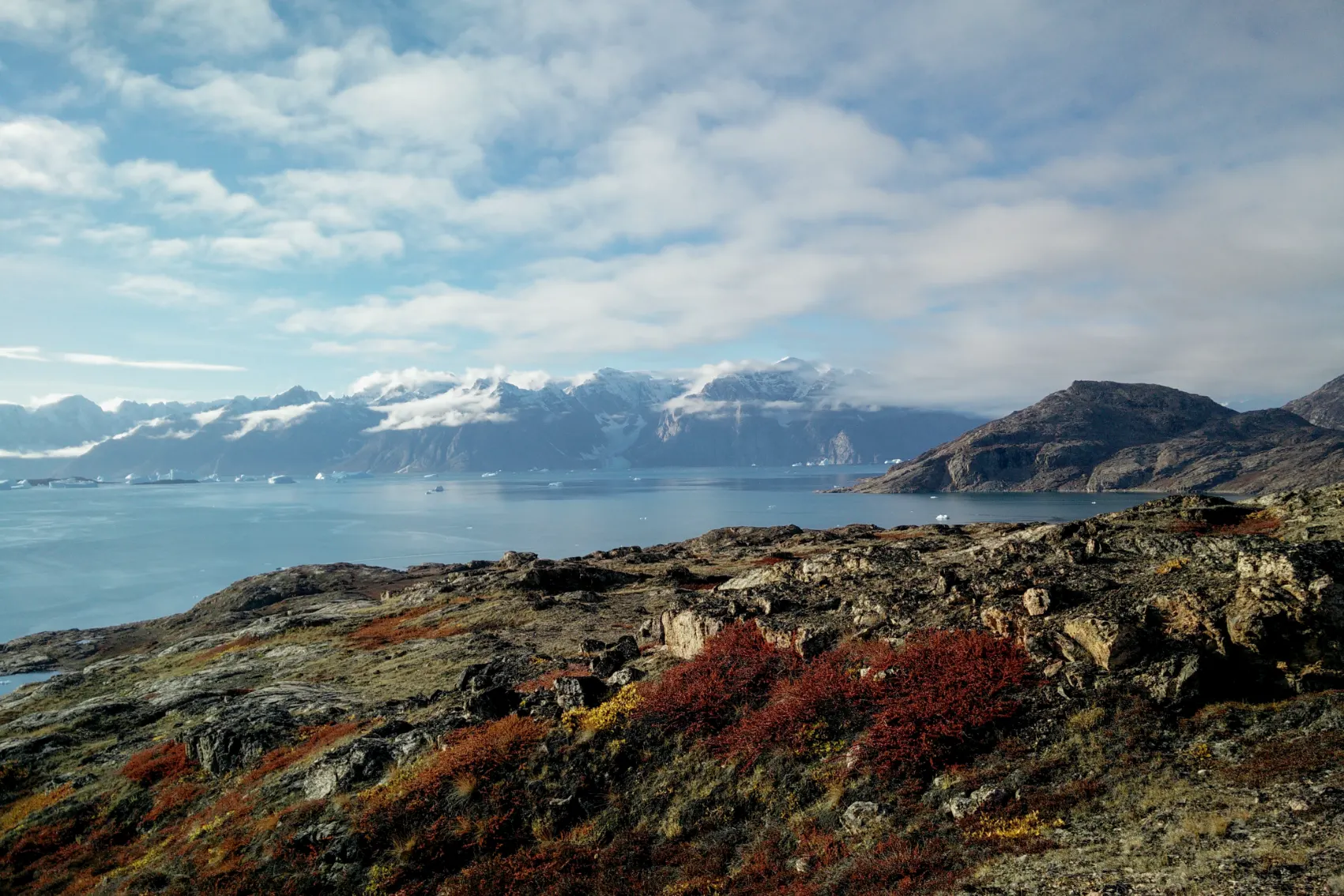 Ice-capped mountains stand tall in the background of Kejser Franz Joseph Fjord, Greenland