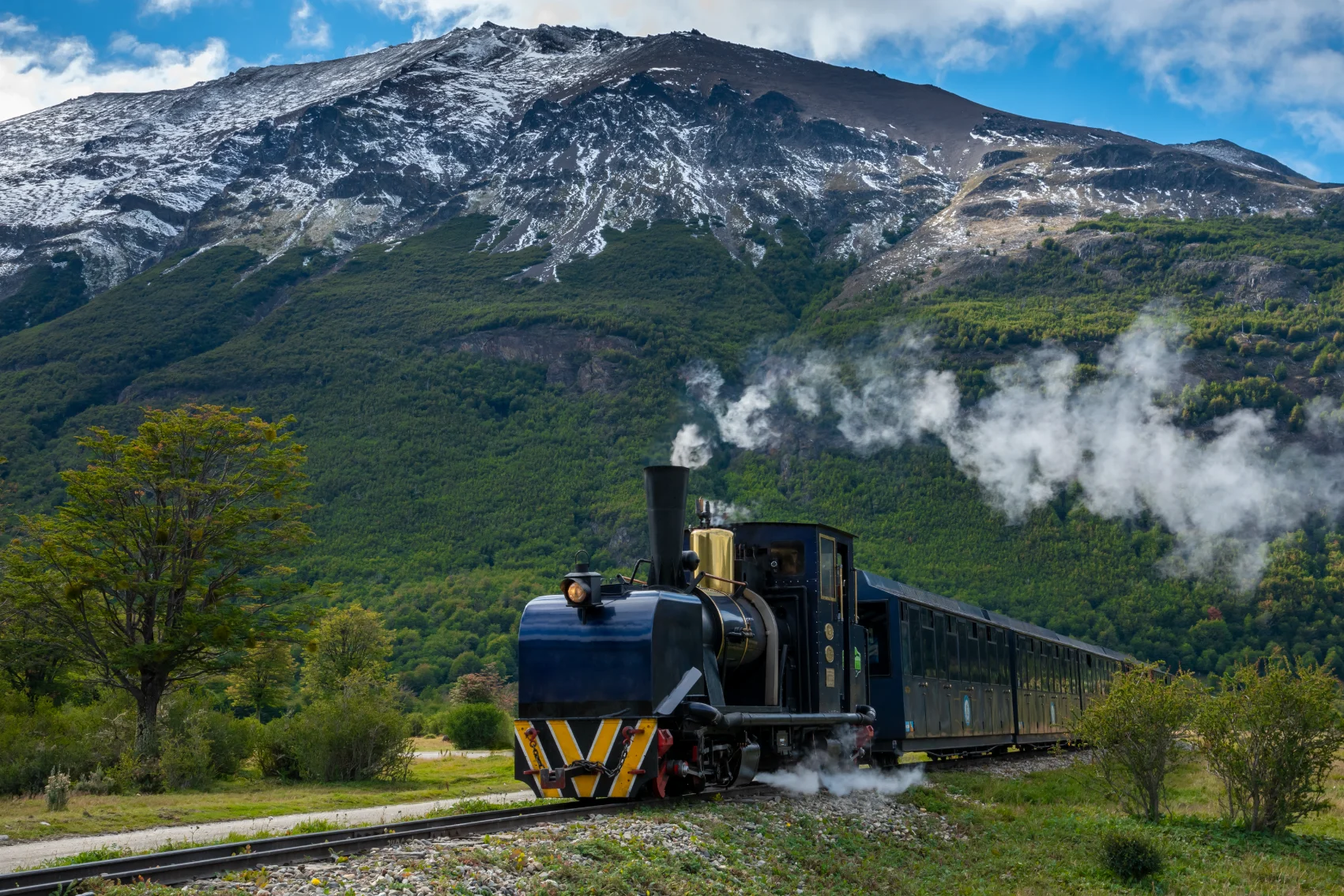 The 'End of the World' train chugs through a mountainous landscape in Ushuaia, Argentina