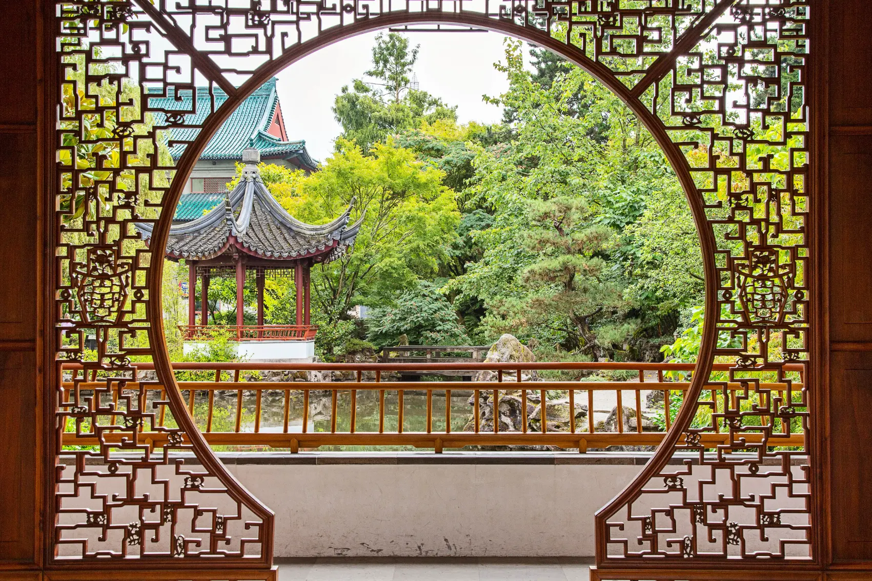 A decorative gate in front of a garden in Chinatown, Vancouver
