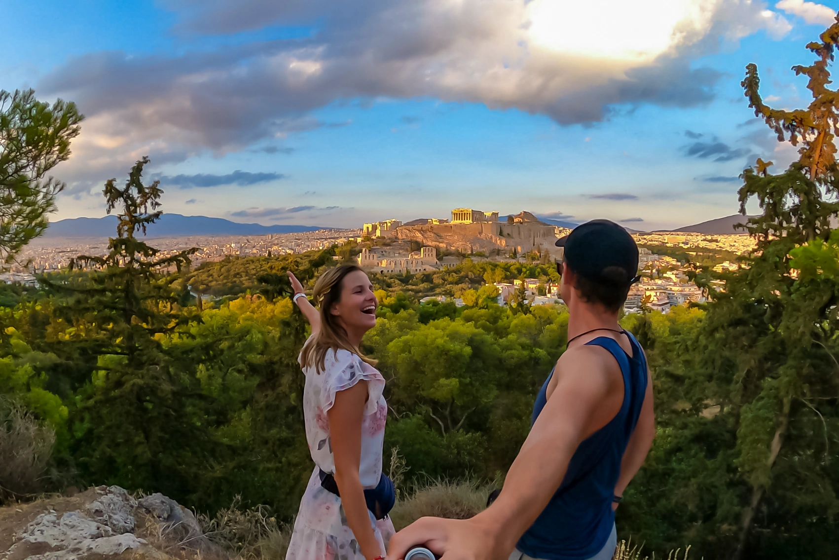 Filopappou Hill, Athens A couple stand on Filopappou Hill overlooking the Acropolis in Athens