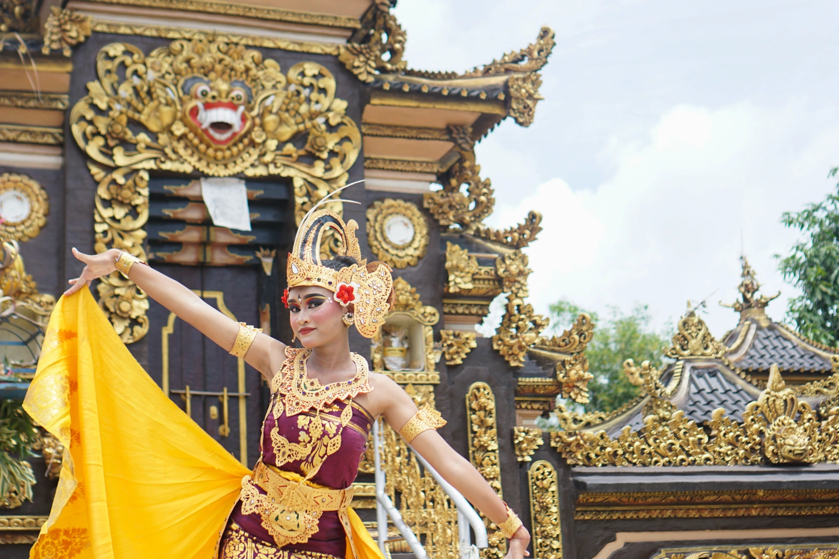 Festivals in Bali A Balinese woman wearing traditional dress dances in front of a temple in Bali