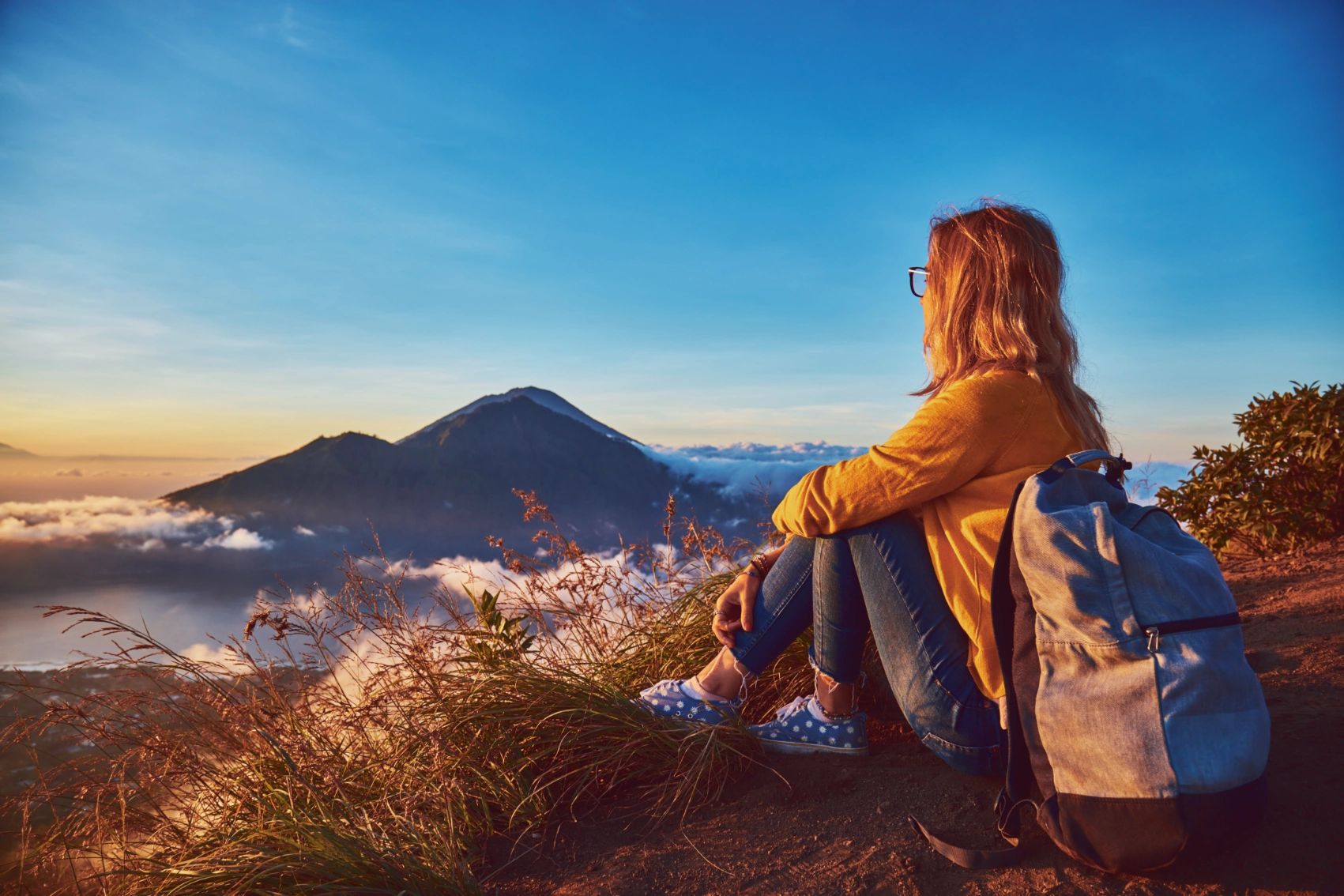 Mount Batur, Bali A woman watches the sunrise from the top of Mount Batur, Bali