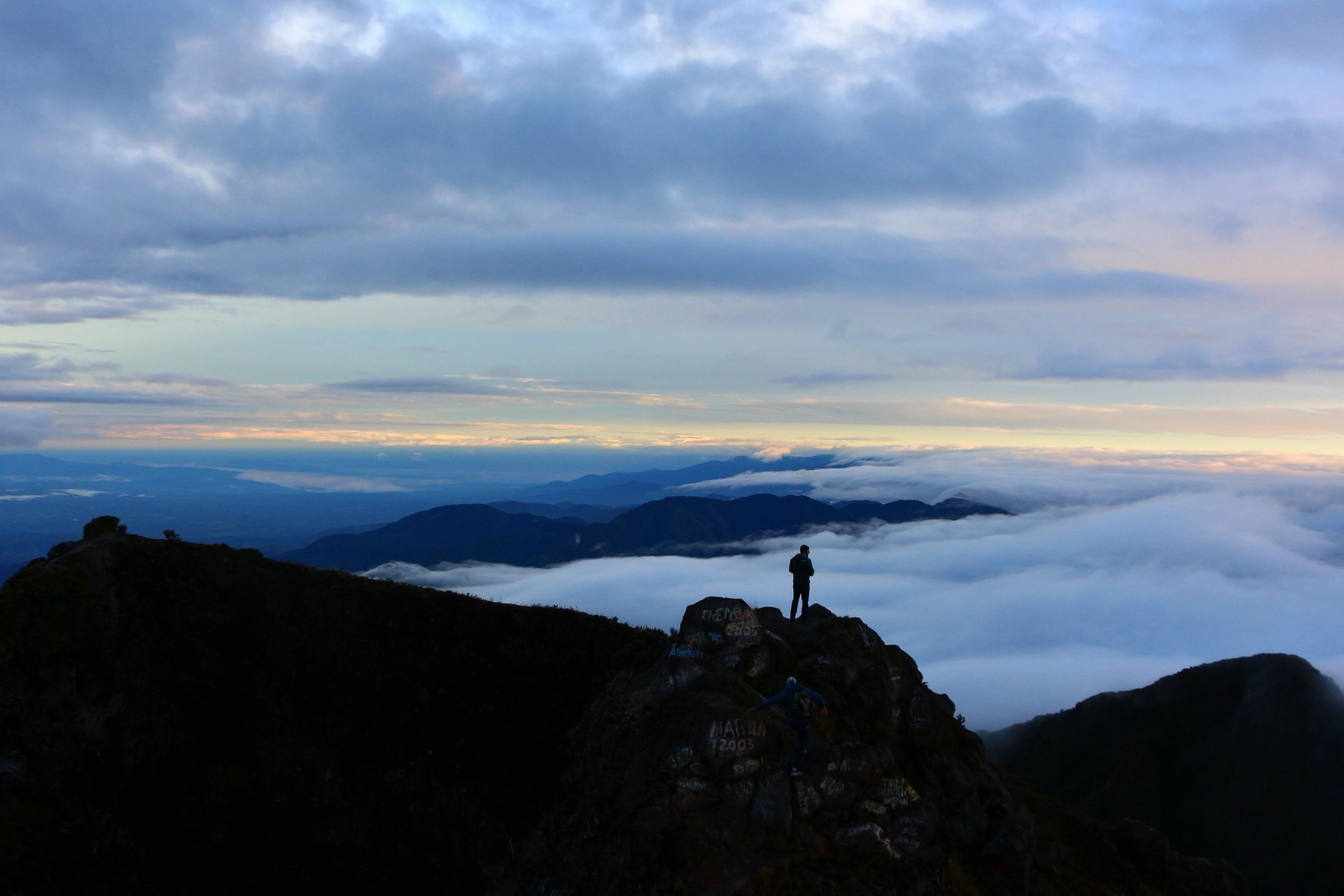 Volcán Barú, Panama A hiker stands above a cloud forest at the summit of Volcán Barú at sunrise
