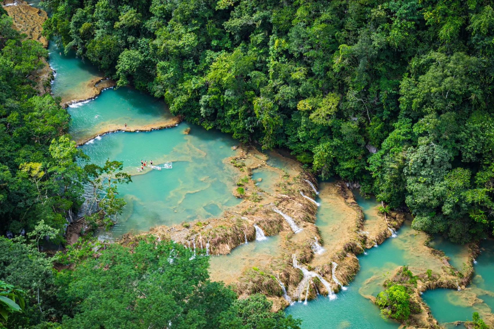Semuc Champey hike, Guatemala Aerial view of people swimming in the pools of Semuc Champey surrounded by jungle in Guatemala