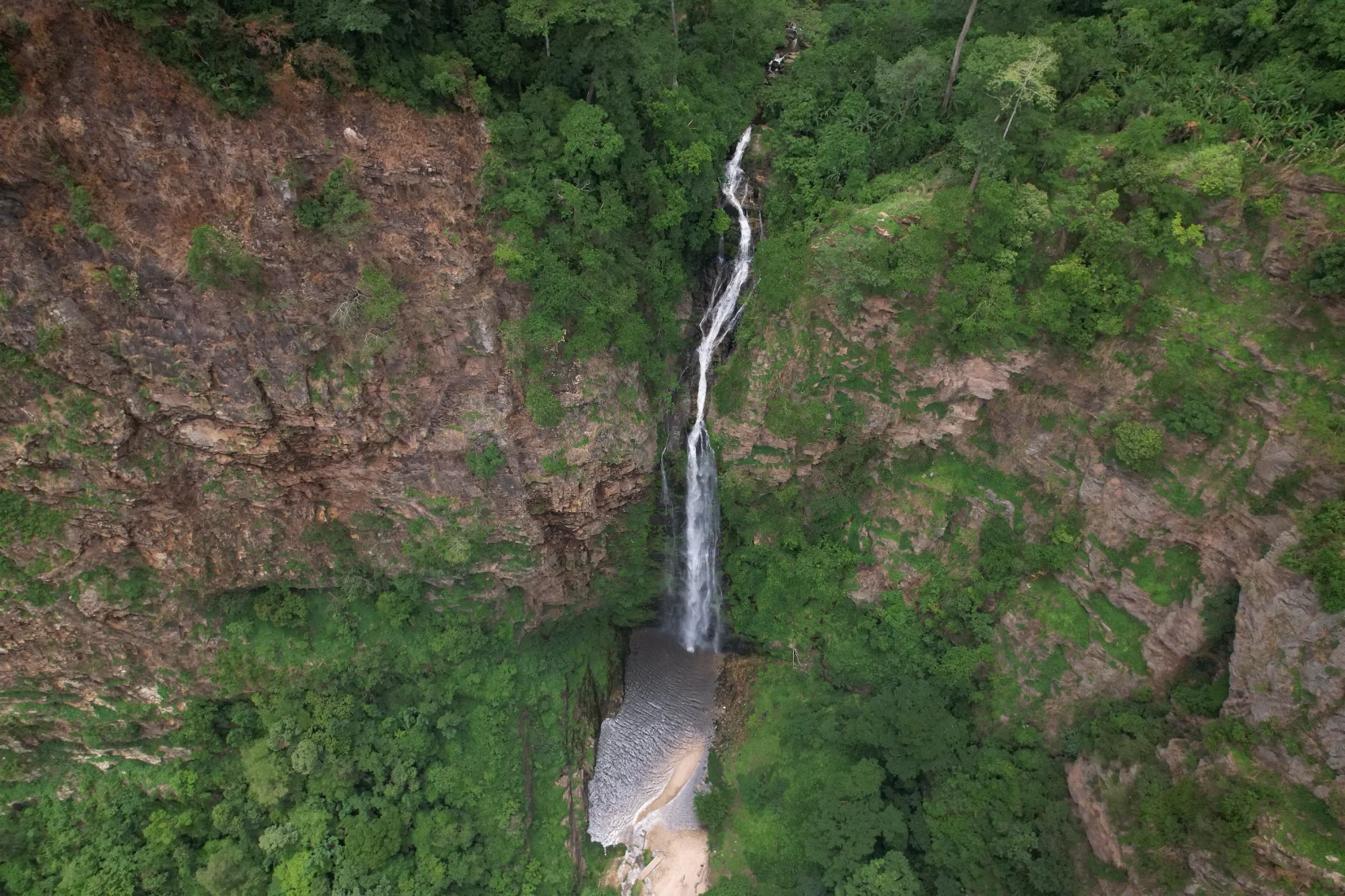 Aerial view of Wli Waterfalls surrounded by dense jungle in Ghana
