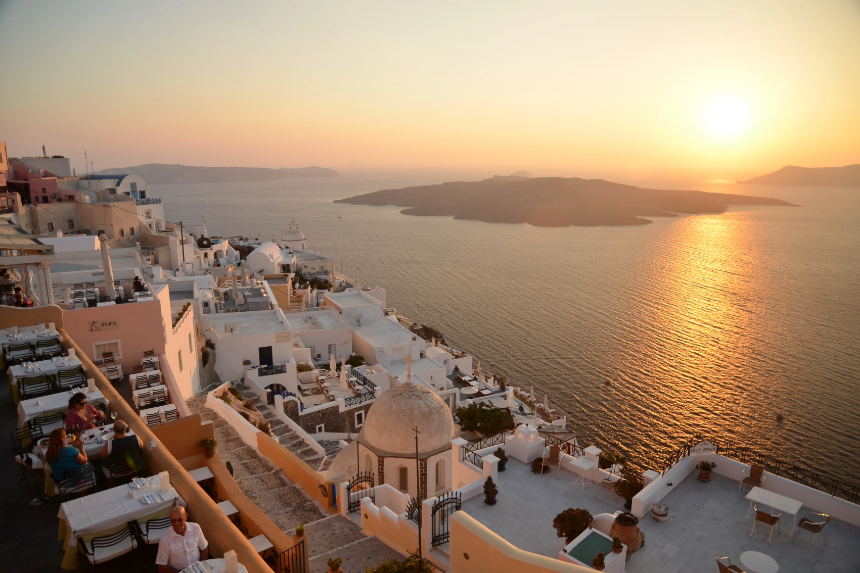 Sunset over whitewashing buildings and the sea in Santorini, Greece