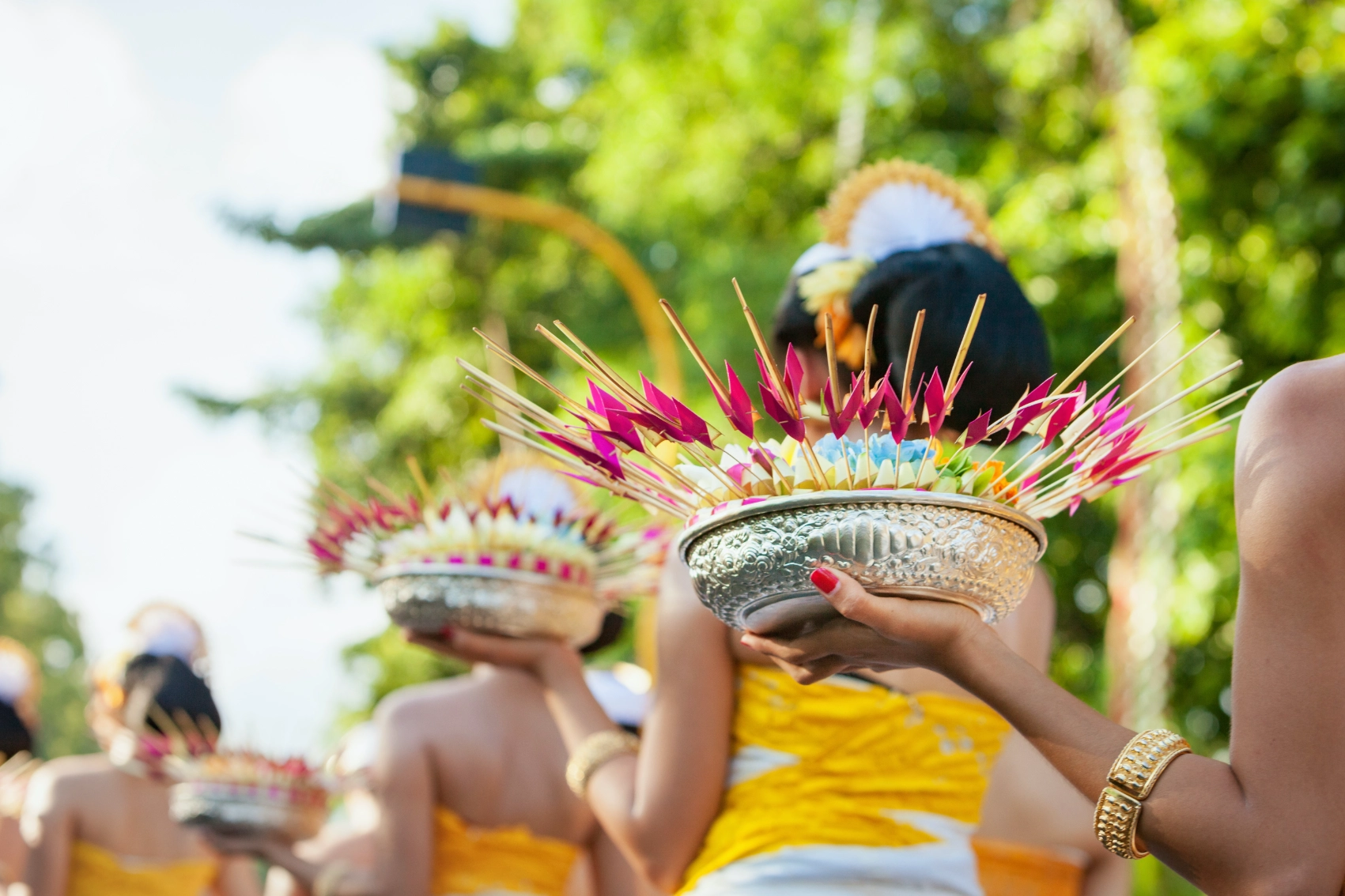 Festivals in Indonesia Women carry bowls of flowers during a festival in Indonesia