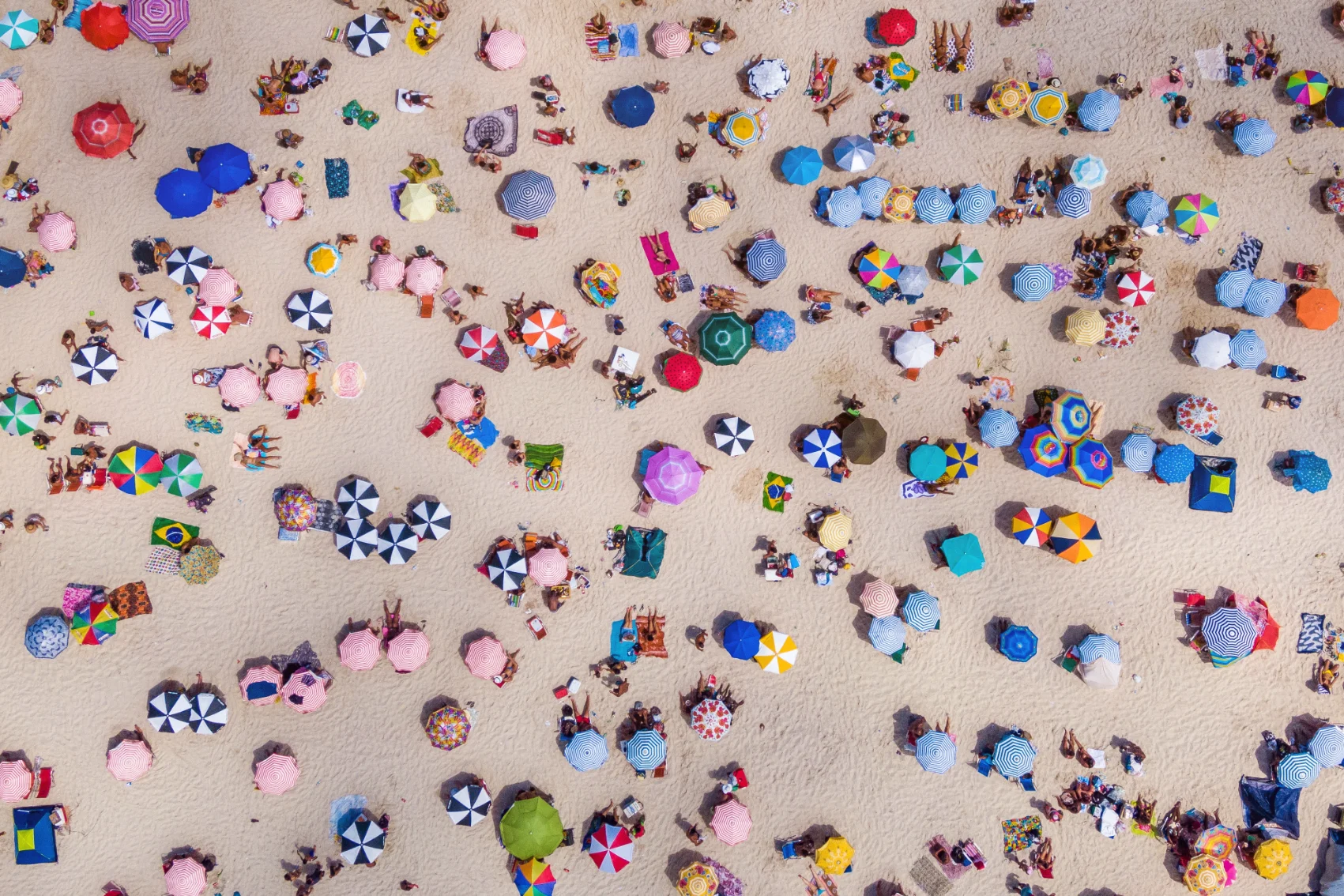 Aerial view of colorful umbrella dotting the sand on Copacabana Beach in Rio de Janiero, Brazil