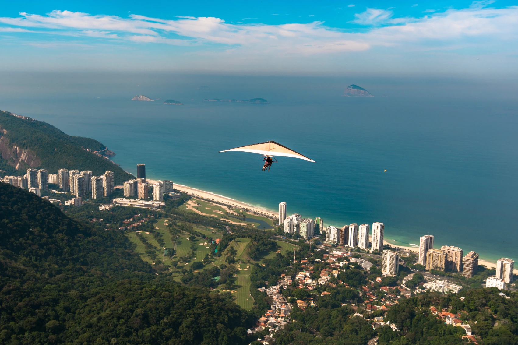 A person is hang gliding over the skyline of Rio de Janiero, Brazil