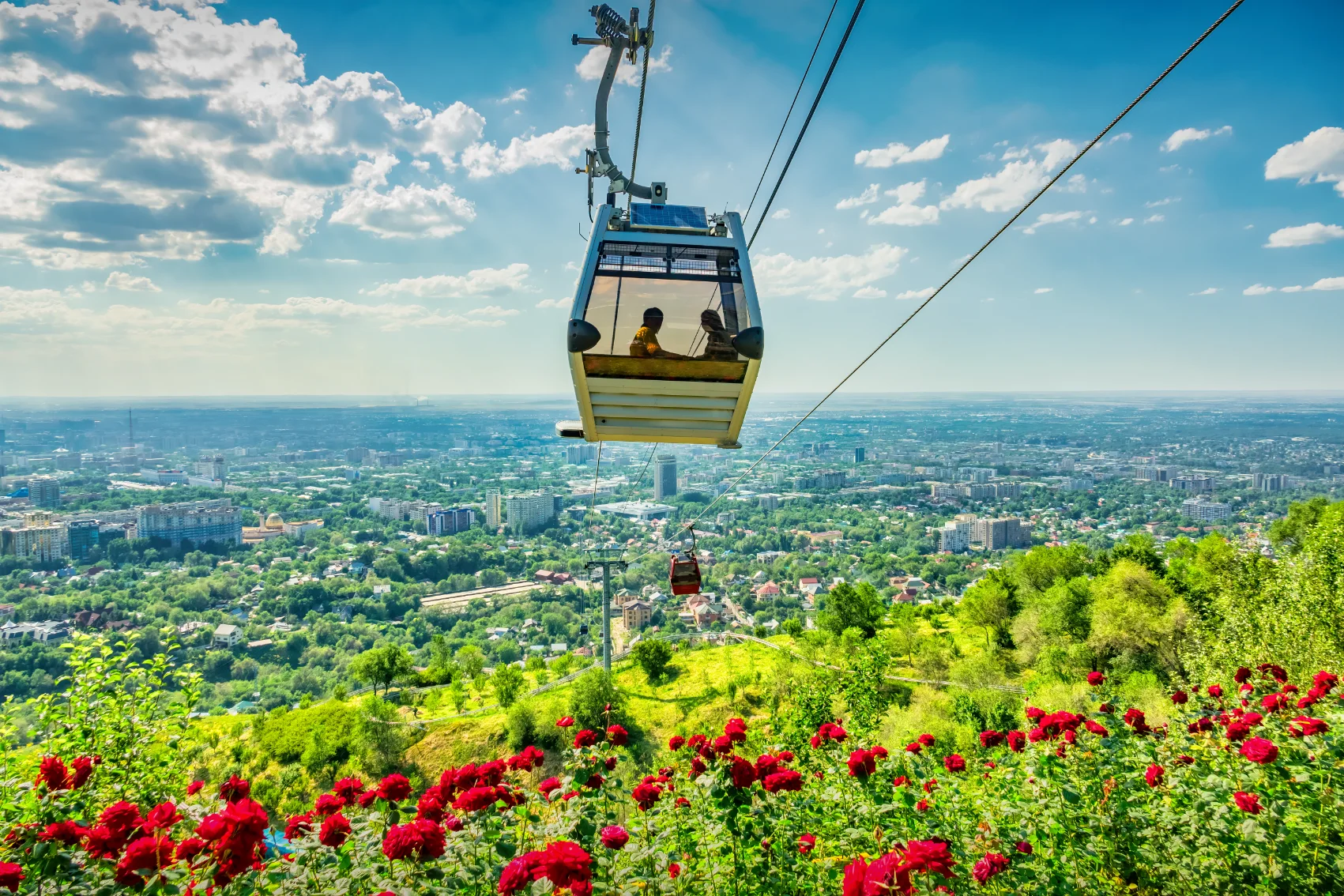 Two people ride in the Kok-Tobe cable car in Green Hill, Almaty
