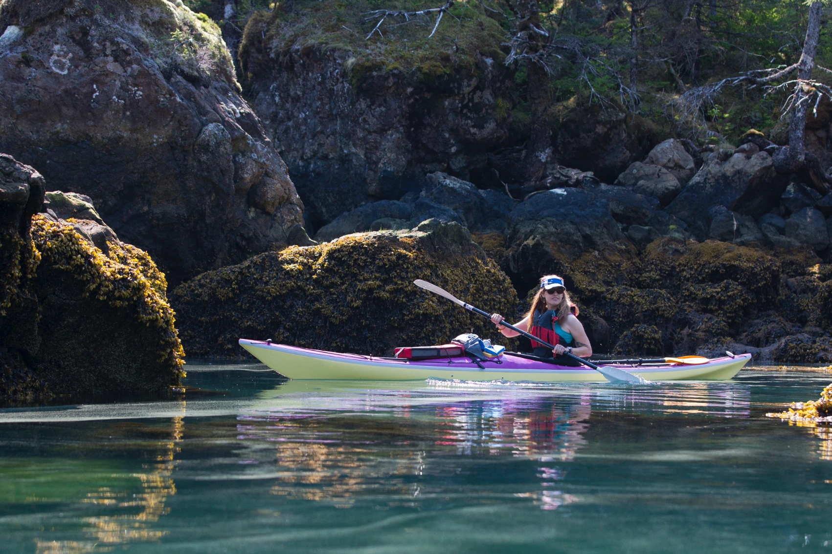 A woman traveller kayaks in Resurrection Bay, Alaska