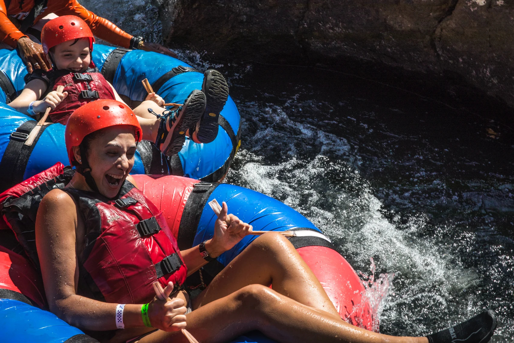 A mother and son ride in inner tubes on a river in Costa Rica on a G Adventures tour