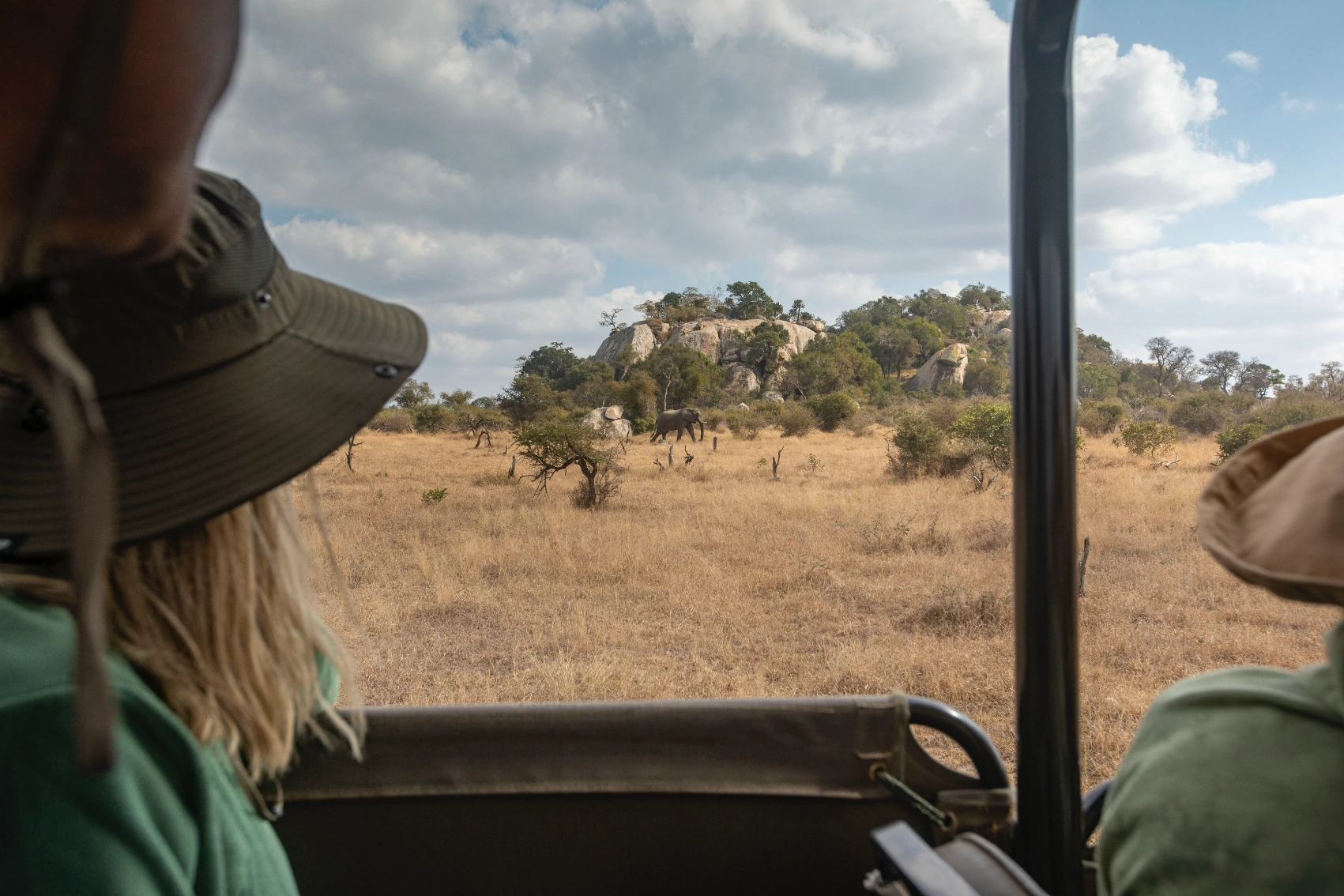 People look out of a safari truck in Kruger National Park, South Africa