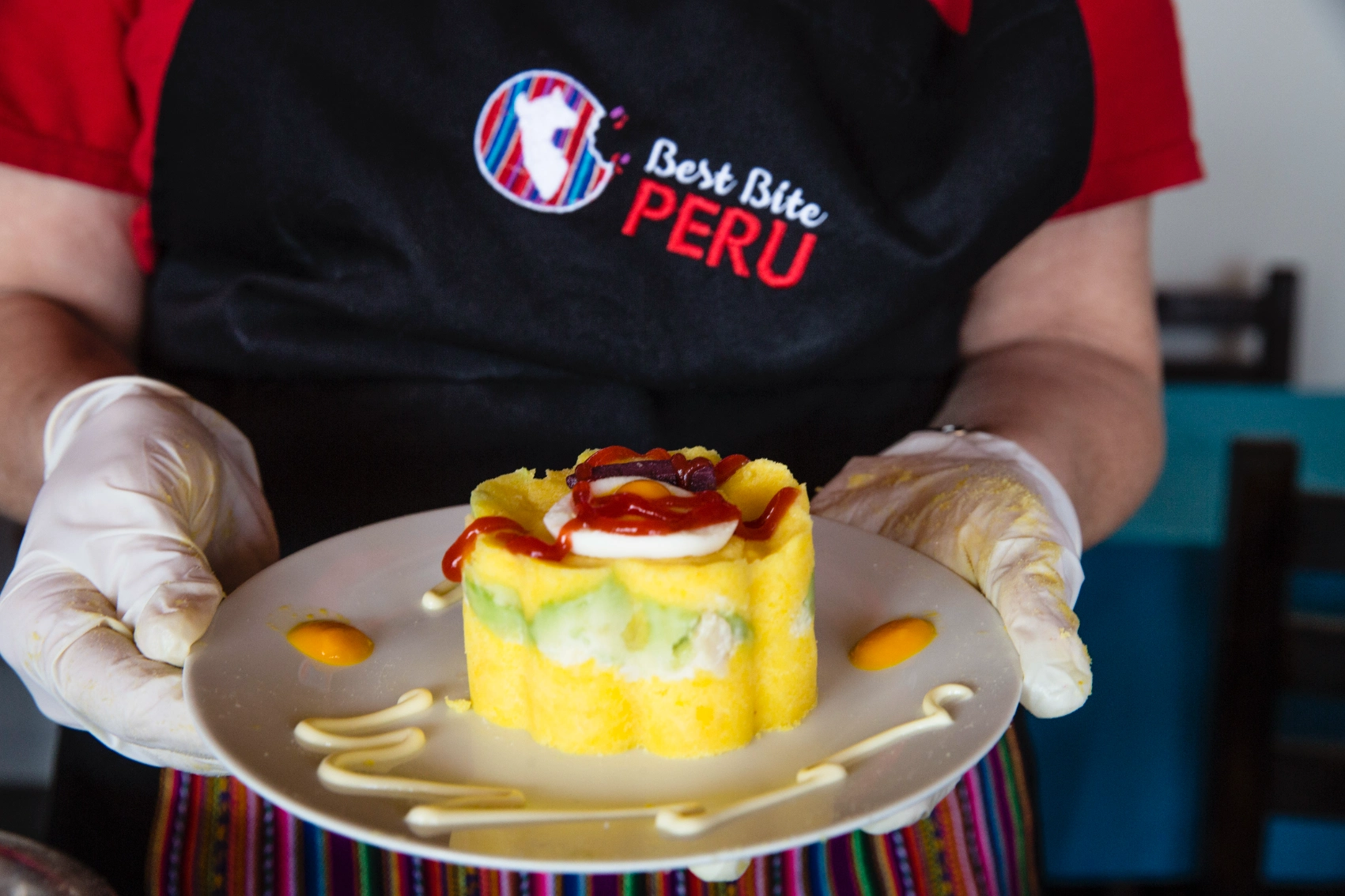 A person holds a cake they made during a cooking class in Peru