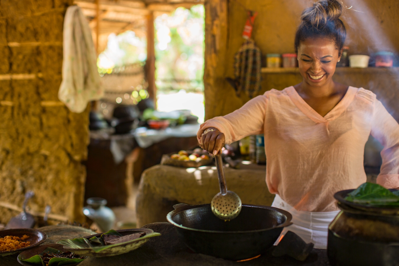 A female traveller cooks at a stove as part of a cooking class in Sri Lanka