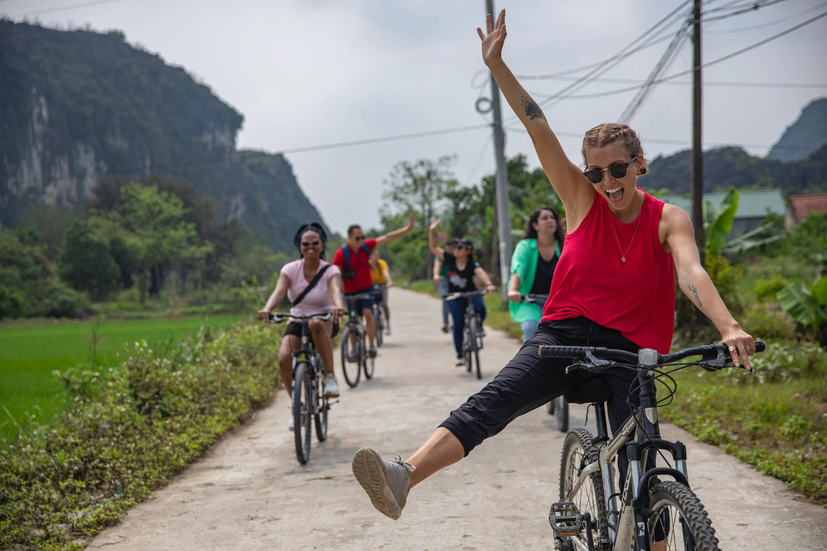 A group of travellers rides bicycles in the countryside of Vietnam