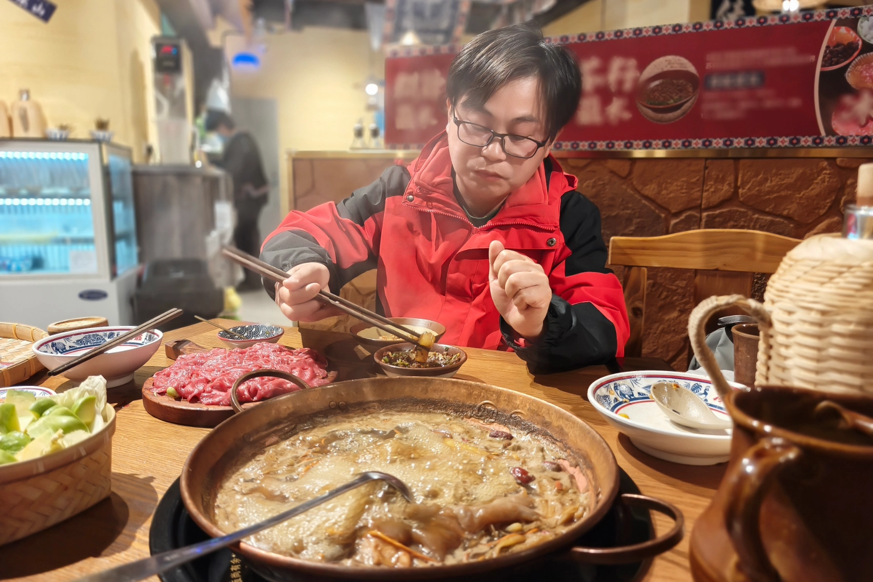Chengdu, China A man sits at a table to eat hotpot in Chengdu, China