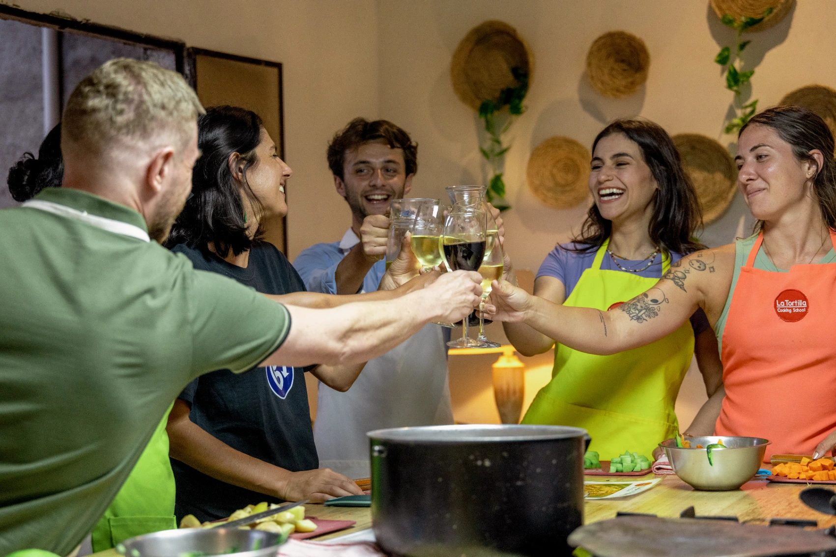 Travellers cheers wine glasses after finishing a cooking class in Guatemala