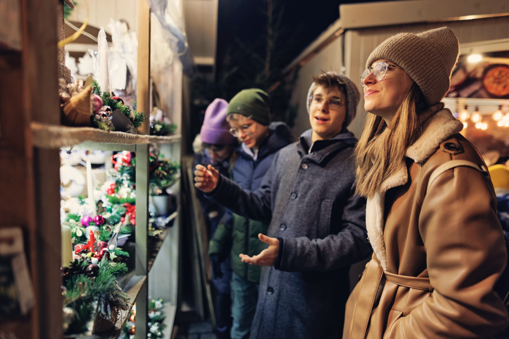 A group of friends looks through a shop window in Kraków, Poland
