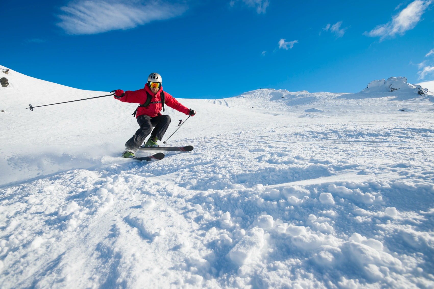 New Zealand skiing A skier turns on a snowy slope in New Zealand on a sunny winter day