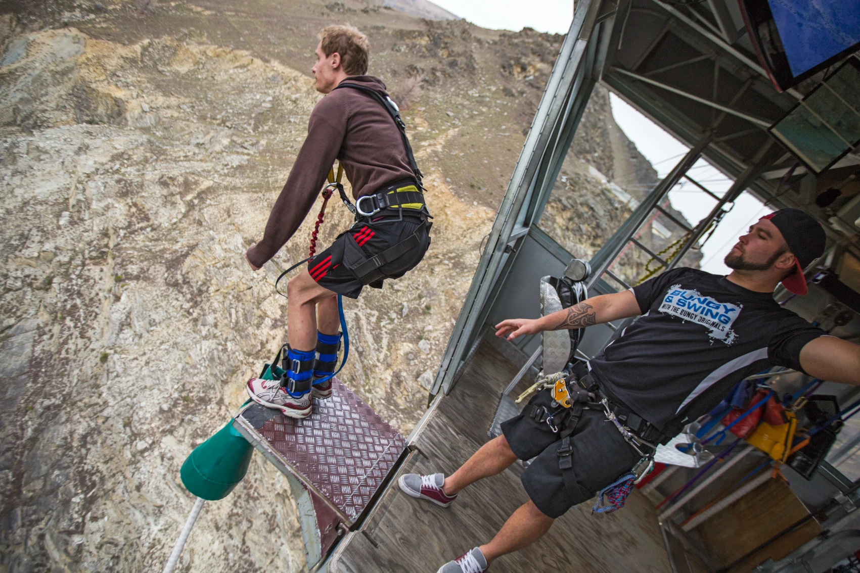 A male traveller stands on a bungee jumping platform in Queenstown, New Zealand