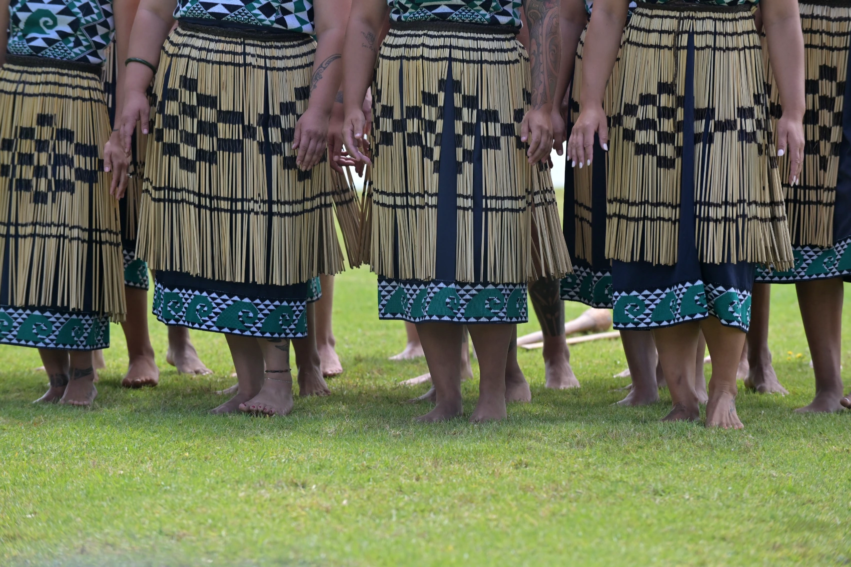 A group of Maori people wear grass skirts on Waitangi Day in New Zealand
