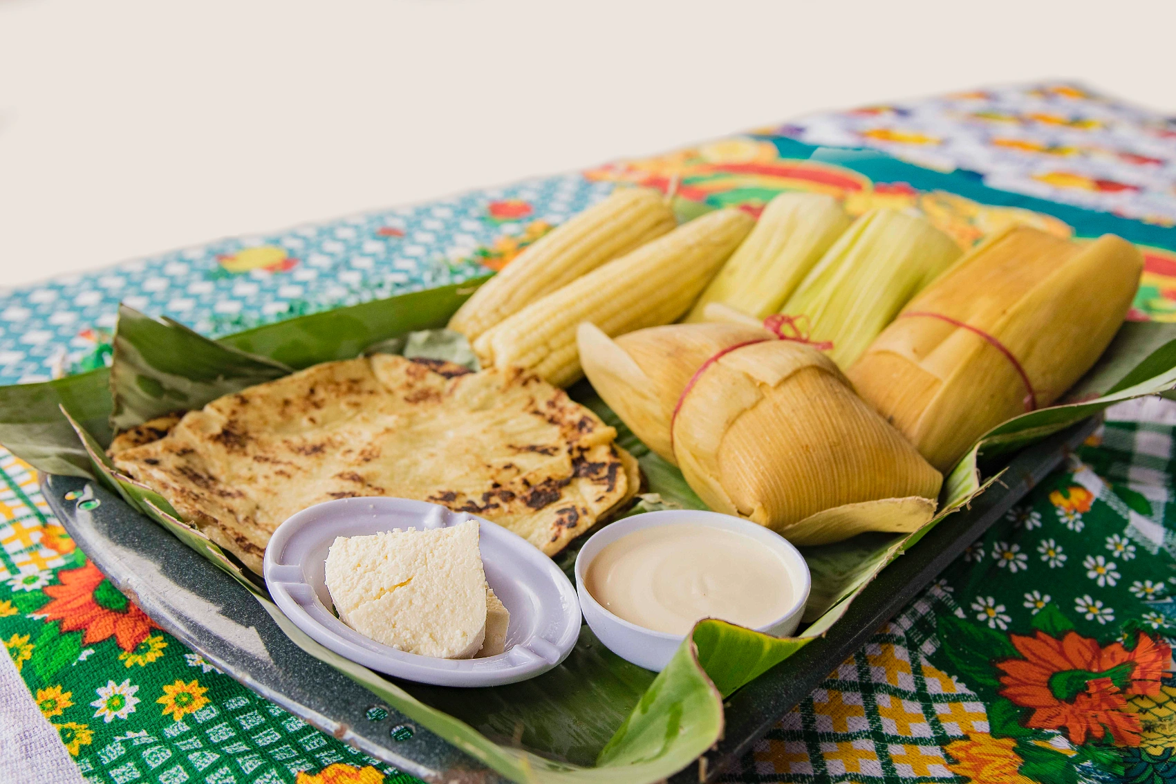 Nicaraguan food A tray of Nicaraguan food, some wrapped in banana leaves, on a table