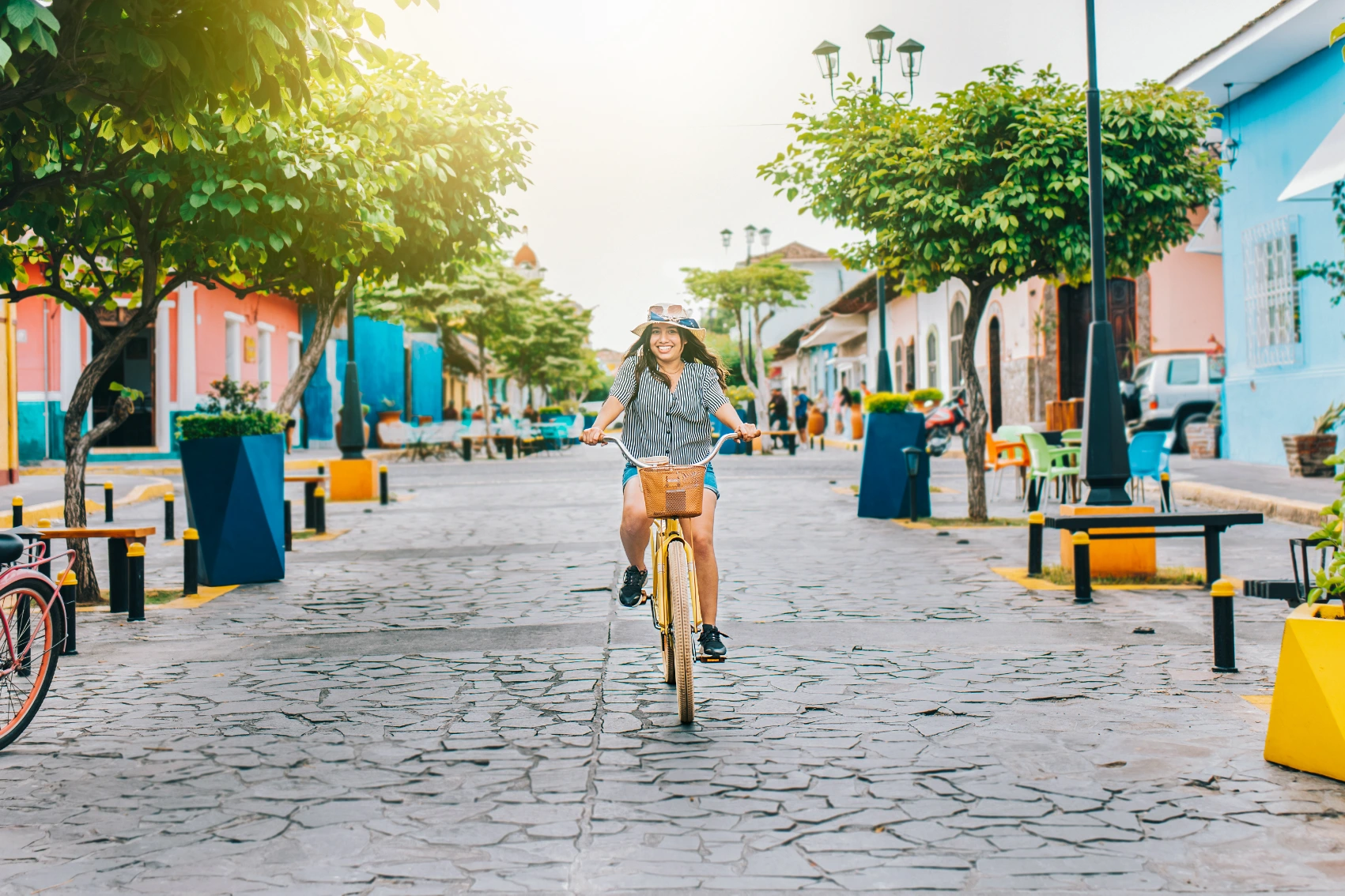 Granada, Nicaragua A female traveller rides a bicycle through Granada, Nicaragua
